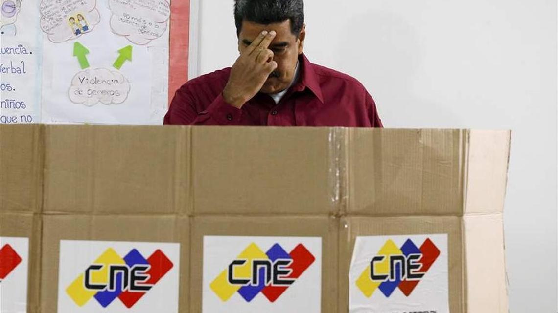 Venezuelan President Nicolas Maduro crosses himself from casting a vote on Sunday.