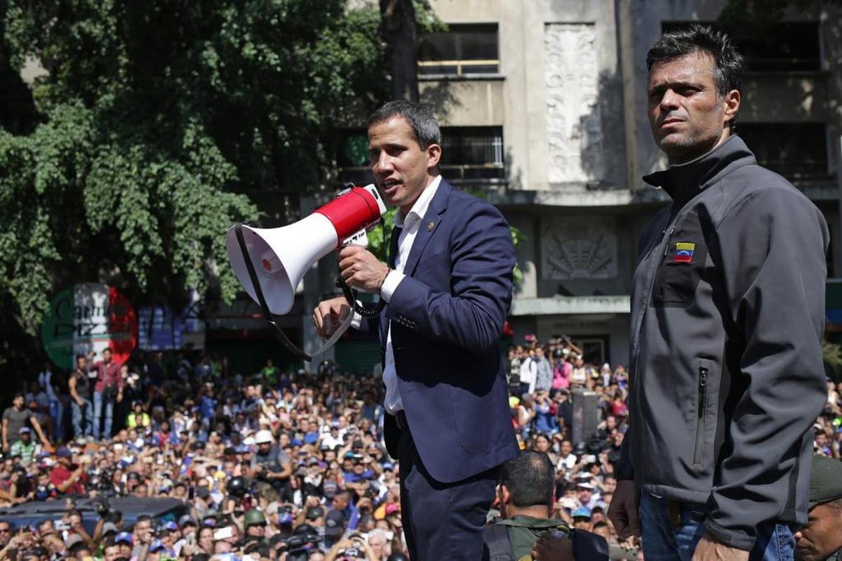 Venezuelan opposition leader and self-proclaimed acting president Juan Guaidó speaks to supporters in Caracas on Tuesday, April 30, next to high-profile opposition politician Leopoldo Lopez, right, who had been put under home arrest by Venezuelan President Nicolas Maduro’s regime. He was also with members of the Bolivarian National Guard who joined his campaign to oust Maduro. Guaidó said there was “no turning back” in his attempt to oust Maduro from power.