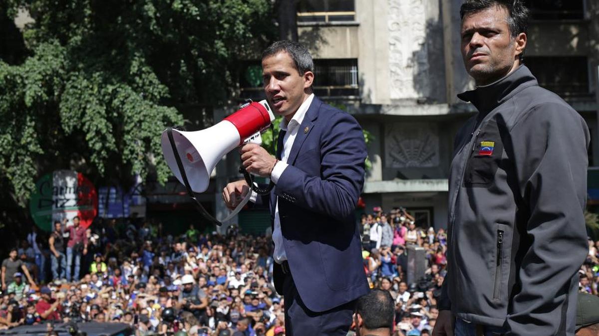 Venezuelan Interim President Juan Guaidó (left) and former political prisoner Leopoldo López speak with supporters on Tuesday in Caracas.