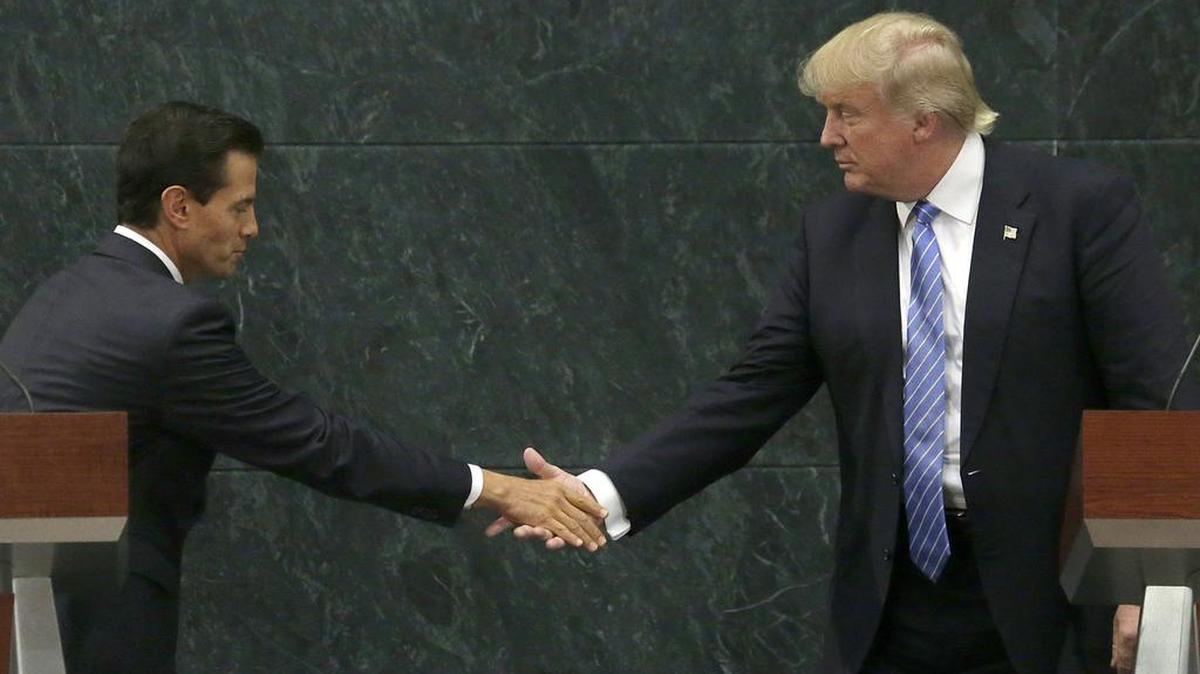 Mexican President Enrique Peña Nieto shakes hands with Donald Trump after a private meeting in Mexico City on Wednesday.