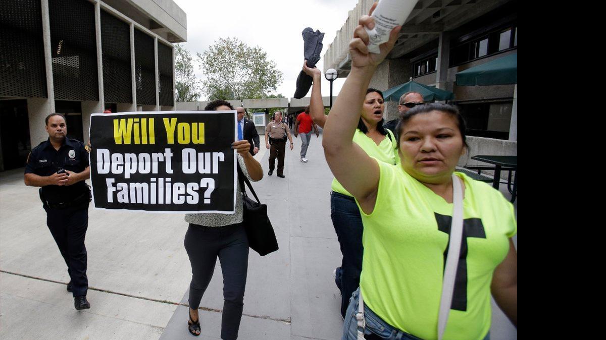 
Pro-immigration demonstrators leave the site where Jeb Bush announced his candidacy. 
