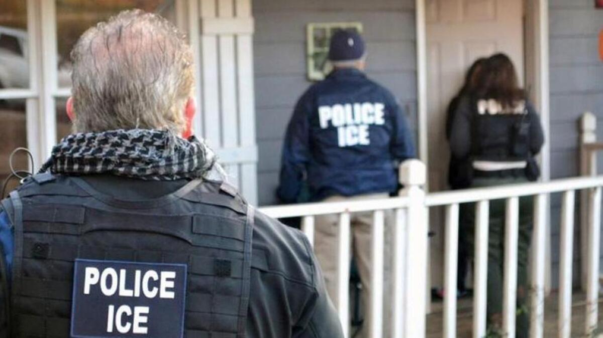 Federal ICE agents at a home in Atlanta during an enforcement operation.