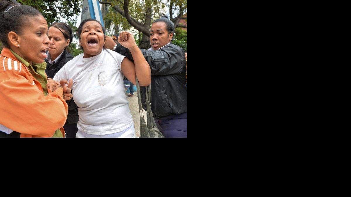 
A member of the Ladies in White opposition movement is arrested by Cuban authorities on Human Rights Day.
