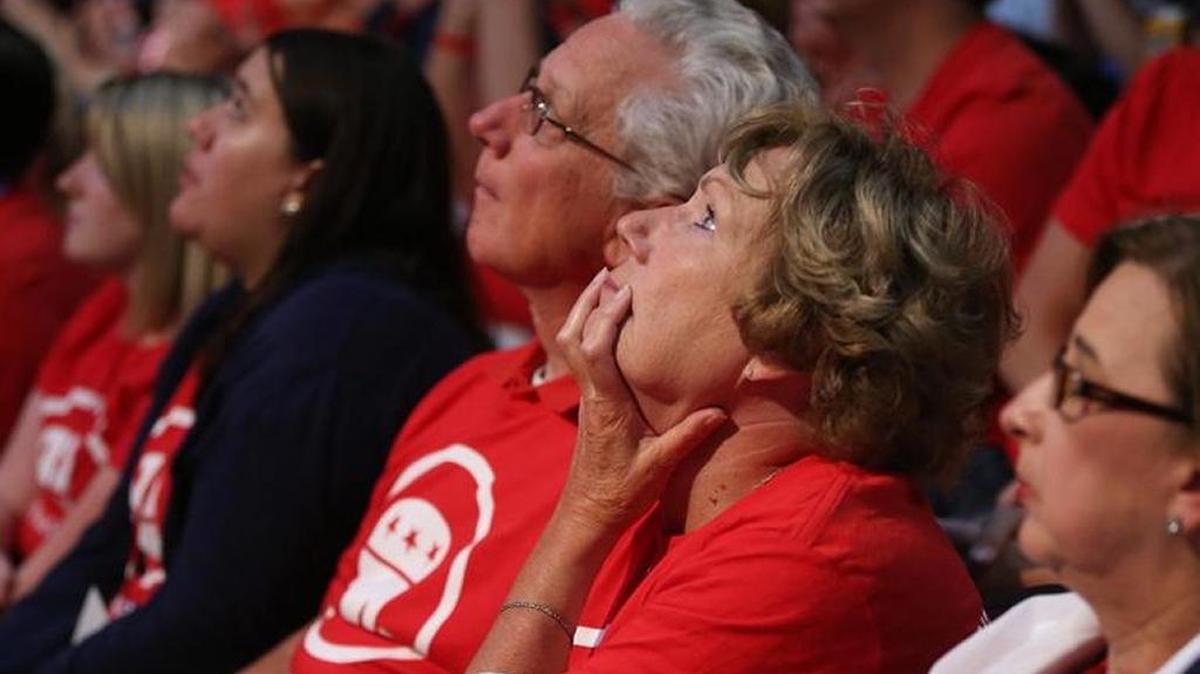 Audience members listen to a serious exchange between the candidates during the first Republican presidential debate in August.