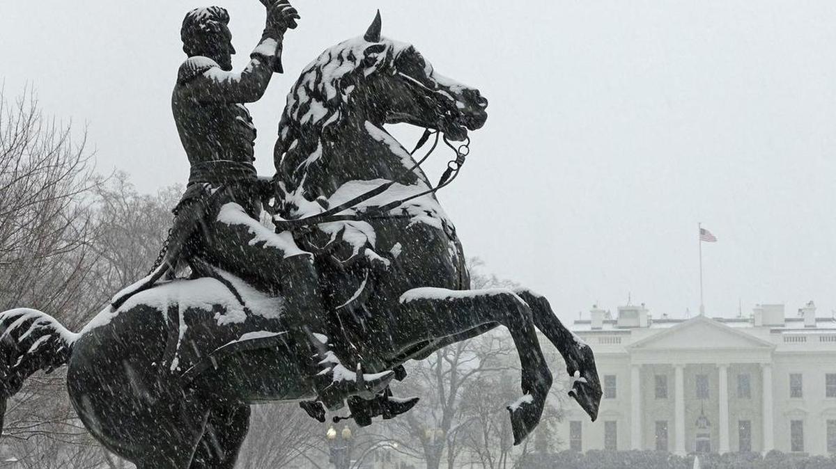A snow-covered statue of Andrew Jackson outside The White House.