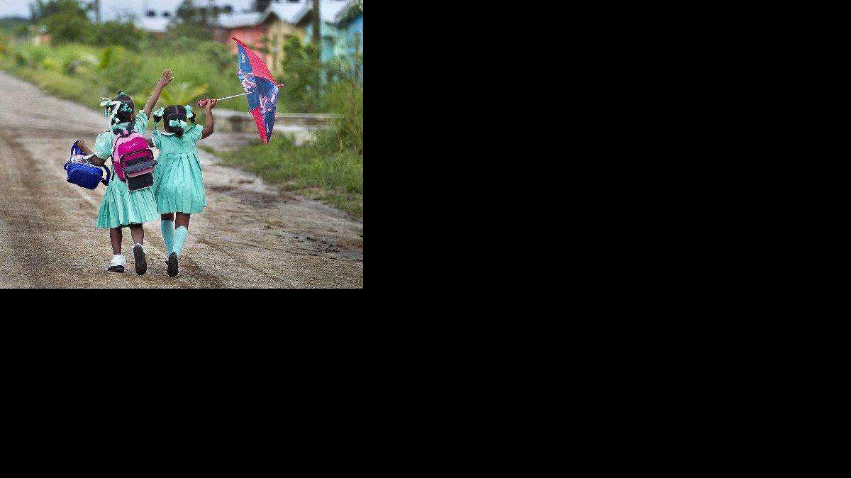 
Two girls walk through the Caracol-EKAM housing development built by U.S. Agency for International Development.
