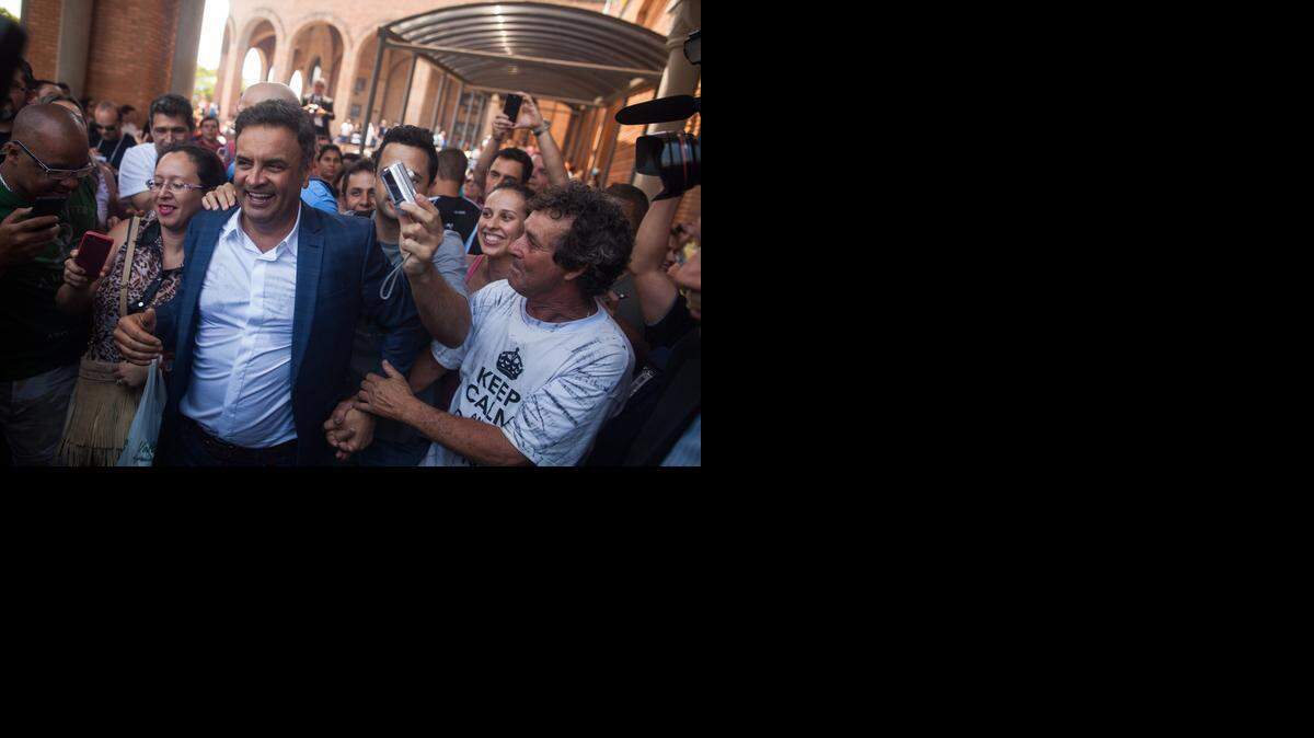
CAMPAIGNING: Brazilian presidential candidate Aécio Neves, surrounded by supporters in Sao Paulo on Sunday, is waging a close race against incumbent Dilma Rousseff. 
