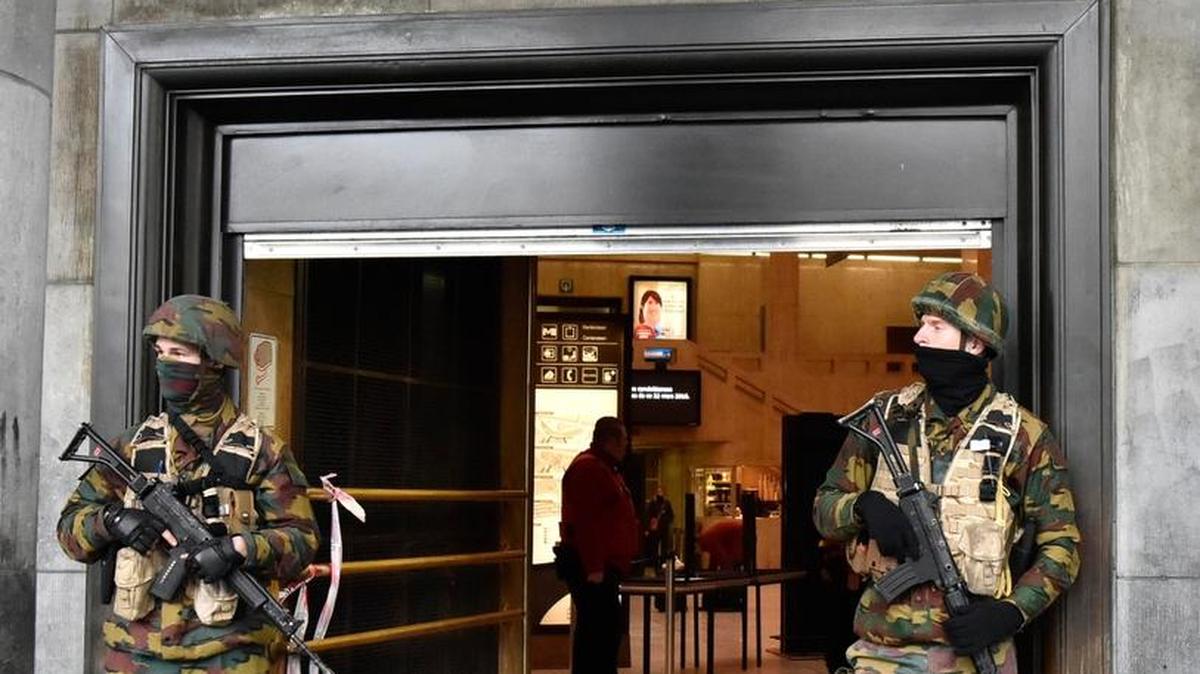 Members of the security forces guard the central metro station in Brussels after attacks at the airport and a metro train killed and wounded scores on Tuesday.