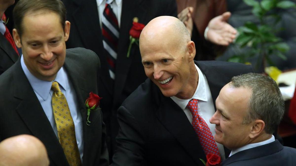 Gov. Rick Scott flanked by Sen. Joe Negron, R-Stuart, left, and Rep. Richard Corcoran, R-Land O’ Lakes makes his way to the podium to deliver his State of the State address last week.