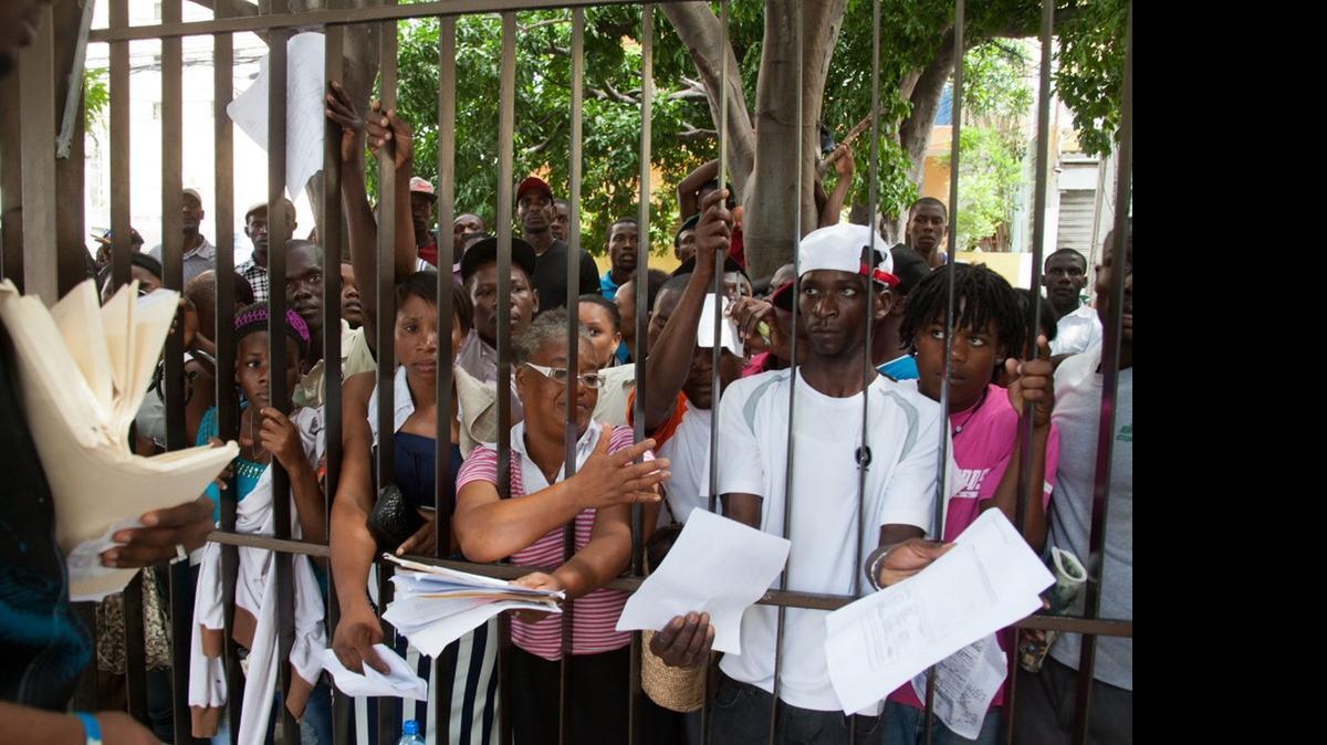 
SEEKING RELIEF: Haitians show officers their documents as they wait to register for legal residency at the Interior Ministry in Santo Domingo. 
