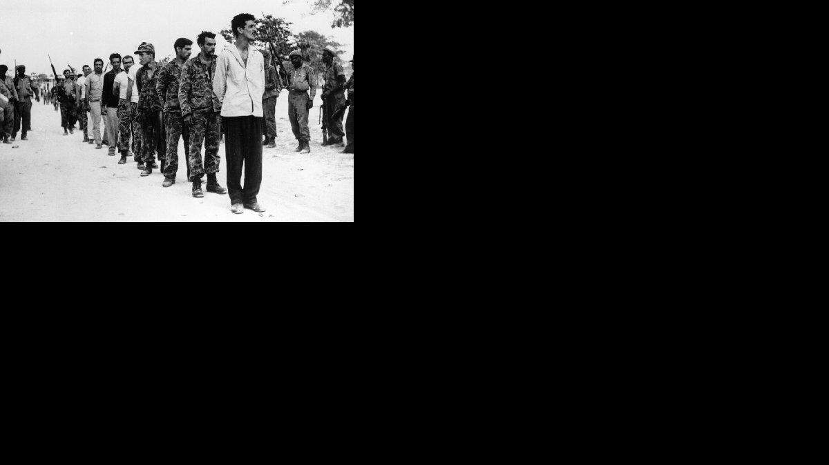 
Captured Cuban exiles are lined up by Castro’s soldiers at the Bay of Pigs.
