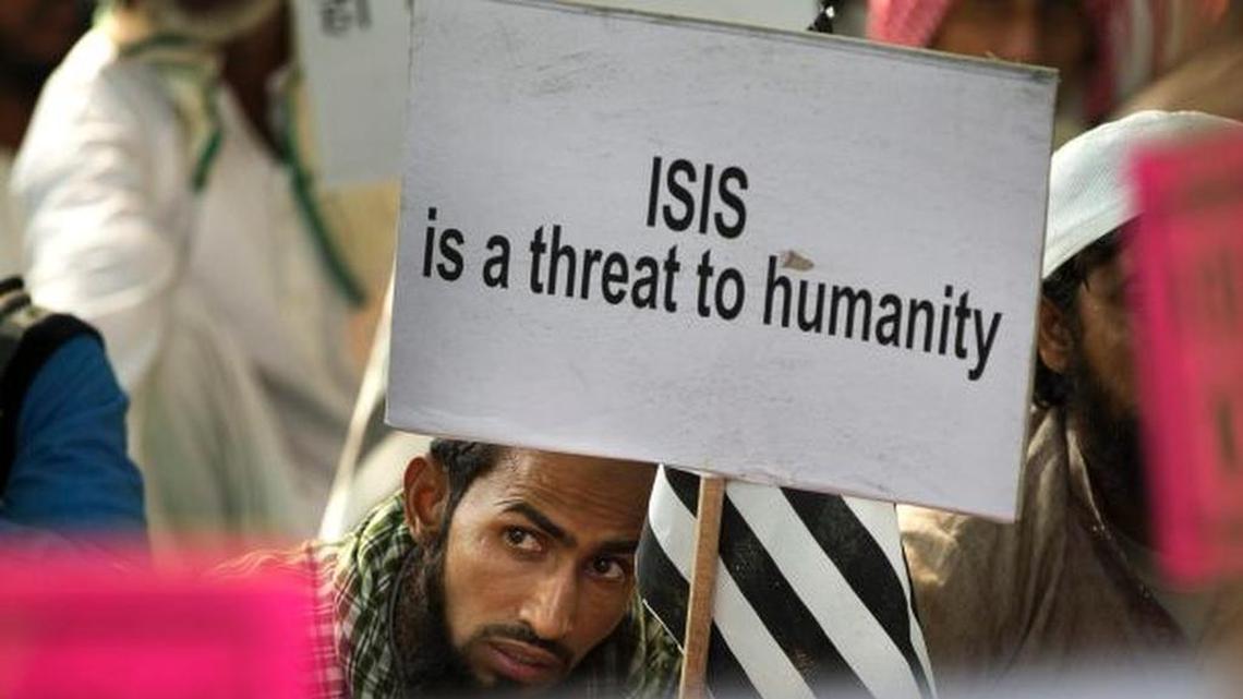 A Muslim protester in New Delhi, India, holds a sign proclaiming his disdain for terrorist group.