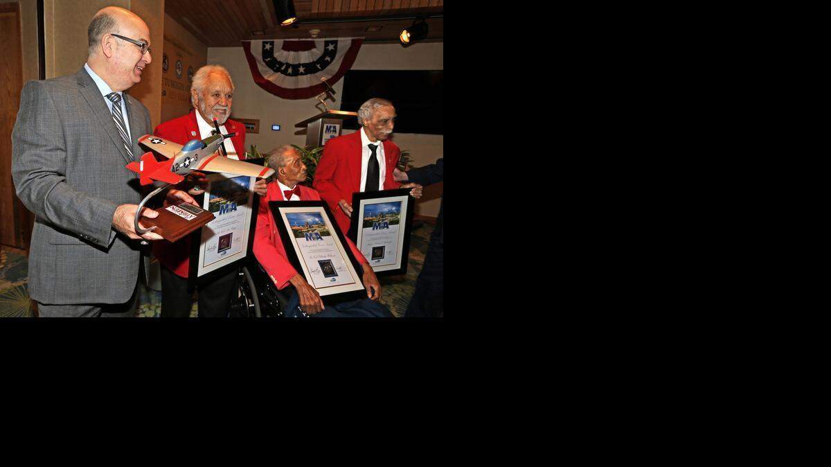
LIVING HISTORY: Miami-Dade Aviation Department Director Emilio Gonzalez presents plaques to, left to right, Tuskegee Airmen Lt. Col. Leo Gray, Lt. Col. Eldridge Williams, and Judge Richard Rutledge, at a luncheon at MIA last week.
