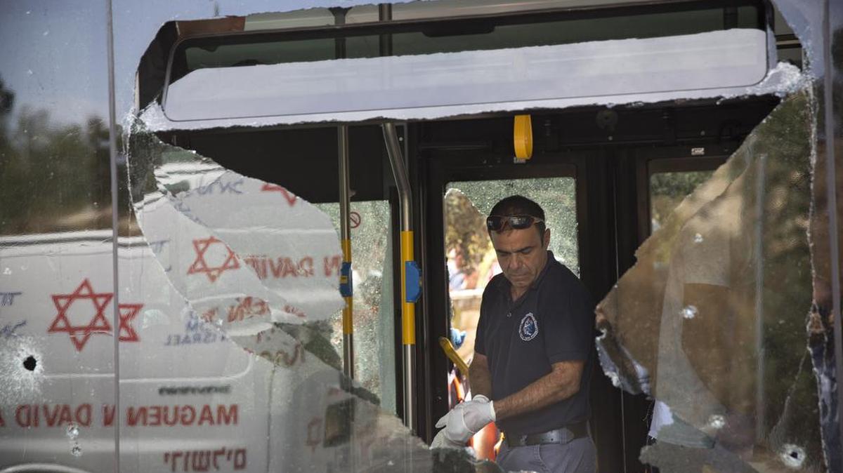 An Israeli police officer inspects the scene of a shooting attack on a bus in Jerusalem by Palestinians earlier this month.