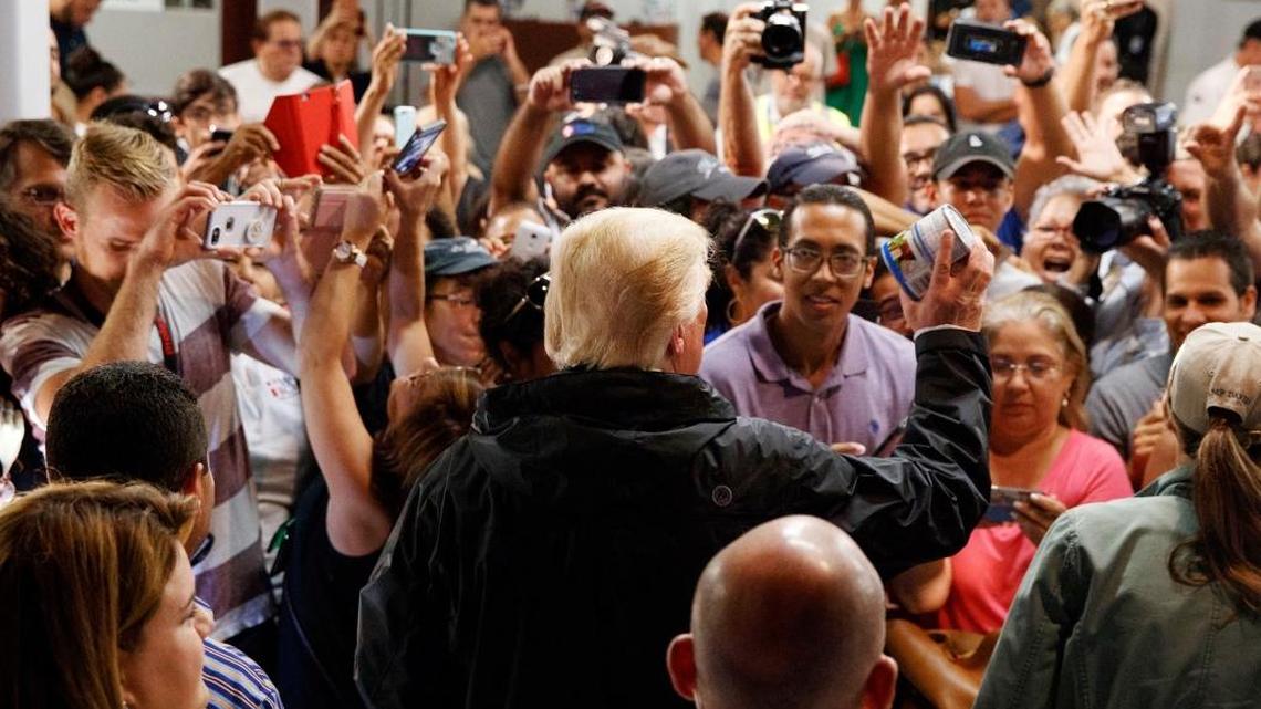 President Donald Trump hands out canned goods and other supplies at Calvary Chapel on Oct. 3, 2017, in Guaynabo, Puerto Rico.