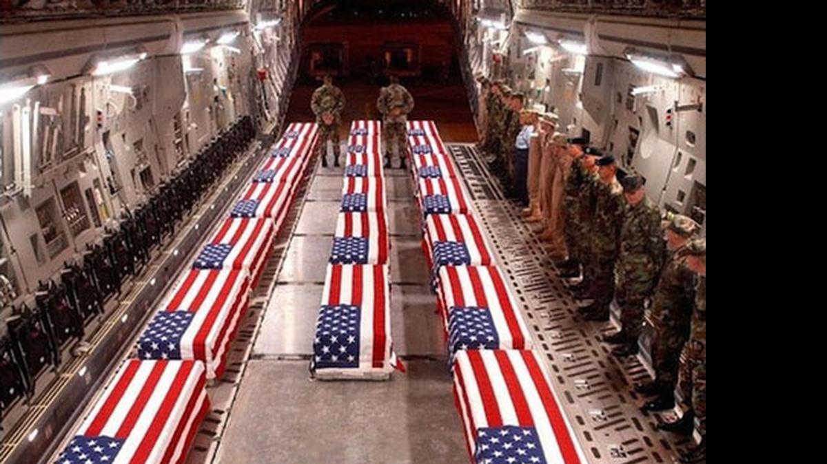 
COSTS OF WAR: Flag-draped coffins of American soldiers killed in action in Iraq being carried home.
