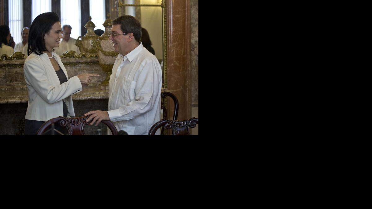 
YOU’RE INVITED: Panama’s Vice President Isabel Saint Malo de Alvarado extends an invitation to Foreign Minister Bruno Rodriguez of Cuba for his country to attend the 2015 summit in Panama.
