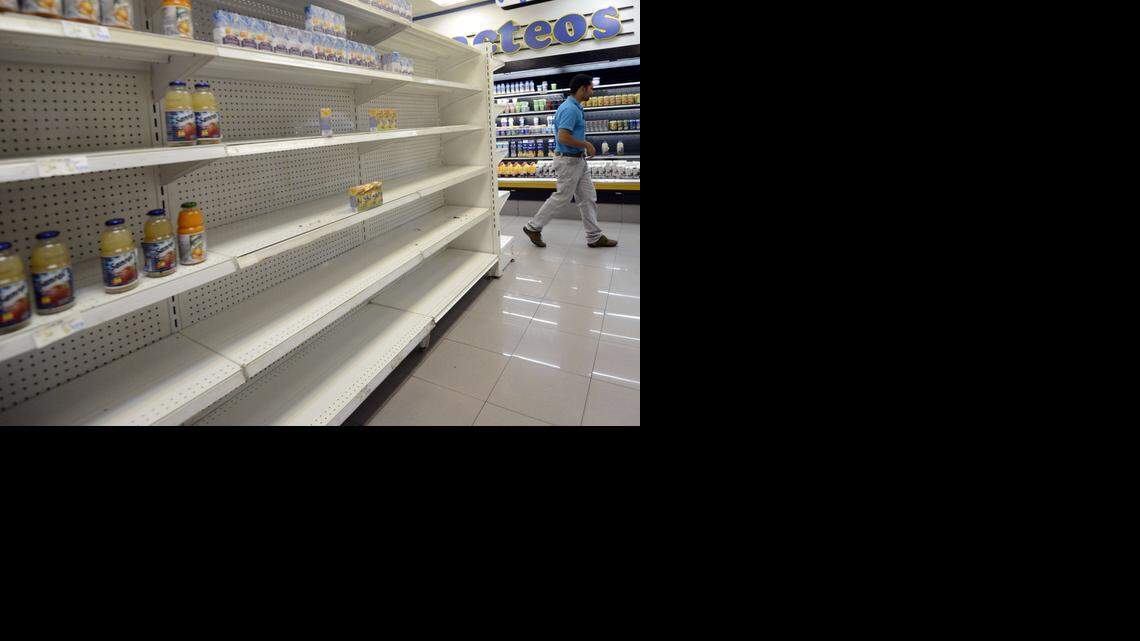 
SLIM PICKINGS: Empty grocery shelves are a sign of the economic crisis in Venezuela.
