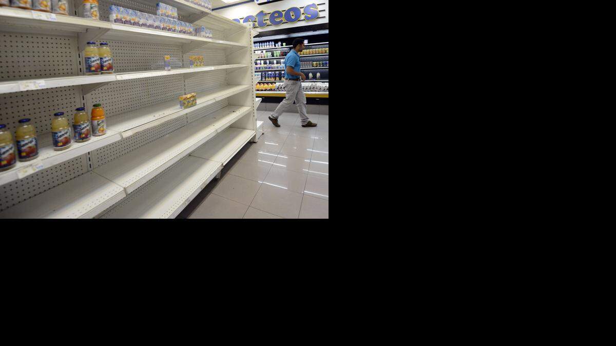 
SLIM PICKINGS: Empty grocery shelves are a sign of the economic crisis in Venezuela.
