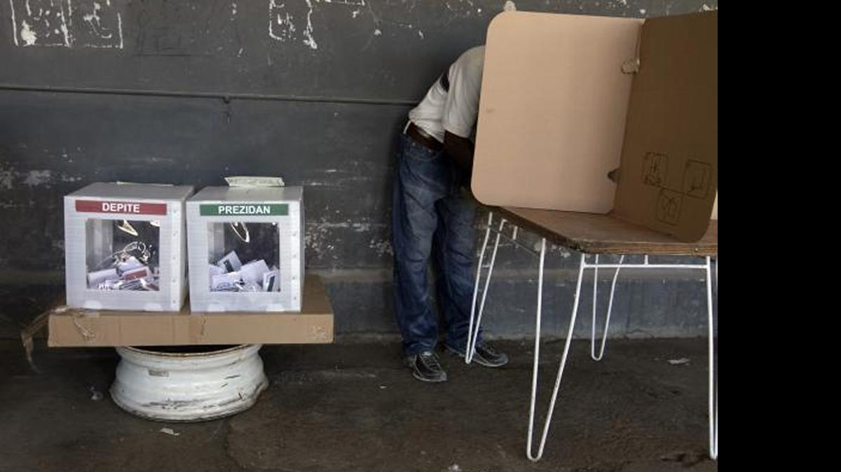 
MAKING A CHOICE: A voter makes his choice for president of Haiti in 2011.
