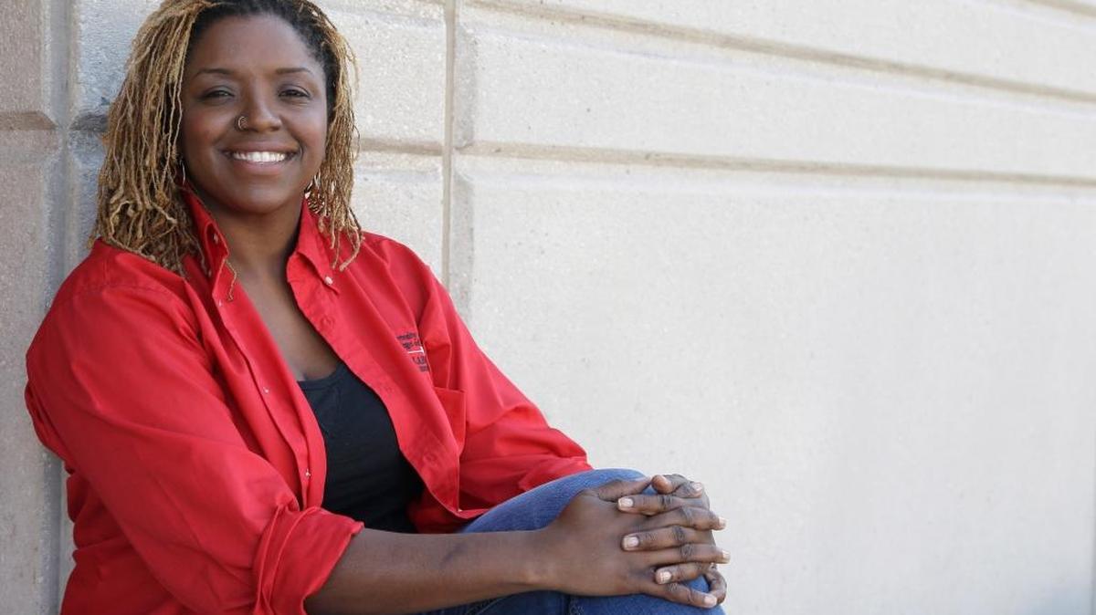 
Roni Dean-Burren poses on the campus of the University of Houston. Dean-Burren is asking publisher McGraw-Hill Education to change the text in a geography book that refers to slaves as workers from Africa.
