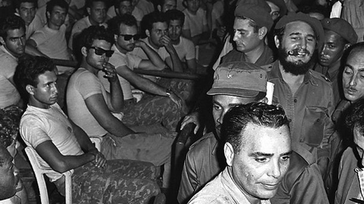 A jubilant Cuban President Fidel Castro (3rd row, R) enters a public trial at Havana’s stadium for the captured members (all seated) of the failed Bay of Pigs invasion in this April 1961 file photo.
