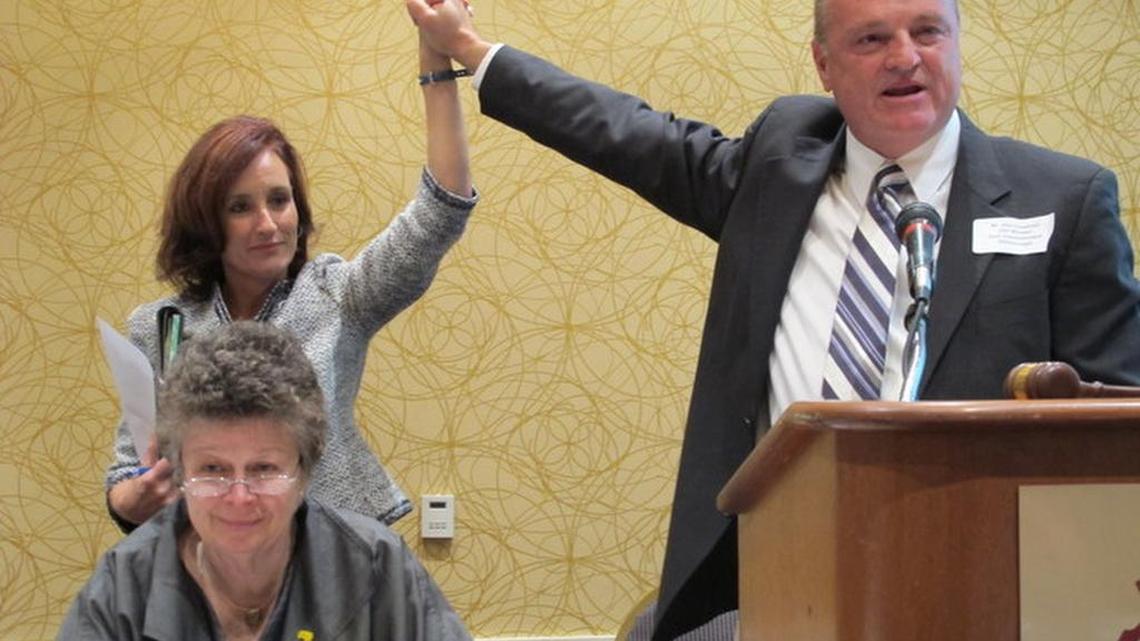 In 2013, Allison Tant, standing to the left, won the position of chair of the Florida Democratic Party. She is being congratulated by Vice Chair Alan Clendenin.