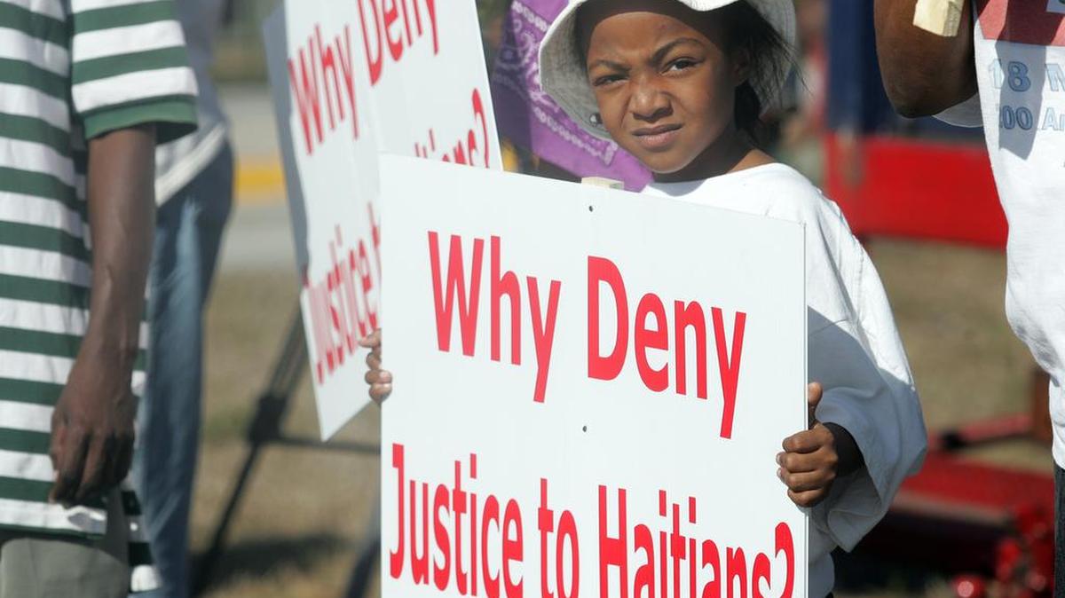 In 2009, Racquel Lanoue, then 8, held sign at a protest outside the Broward Transitional Center in Pompano Beach, criticizing detentions and deportations of undocumented Haitian migrants.