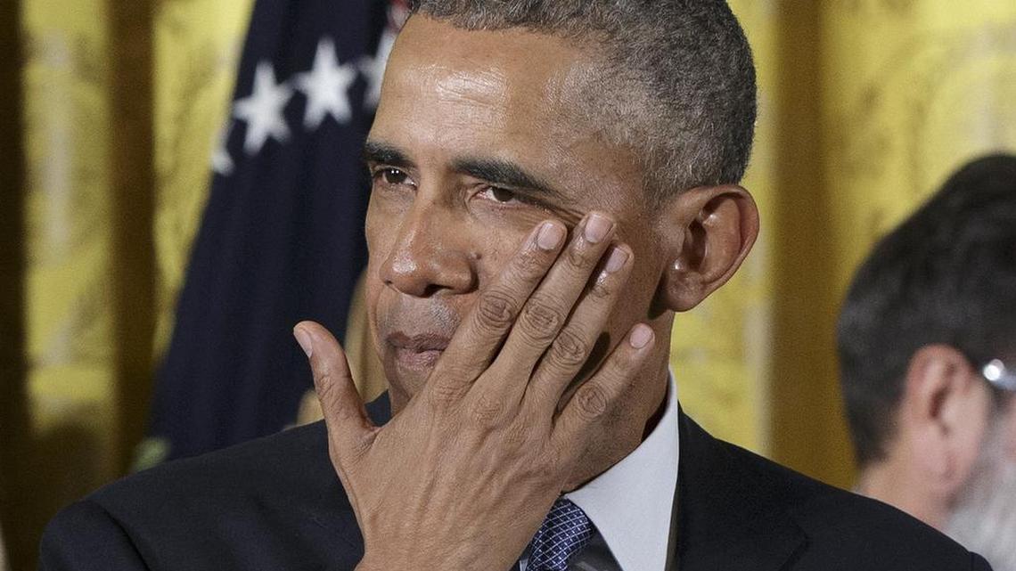 President Obama wipes tears from his face as he outlines steps his administration is taking to reduce gun violence.
