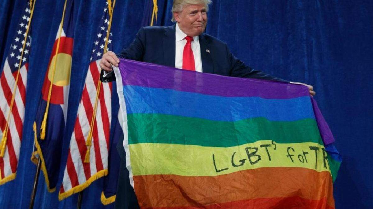 At a pre-election rally in 2016, Donald Trump held a rainbow flag a supporter handed him.