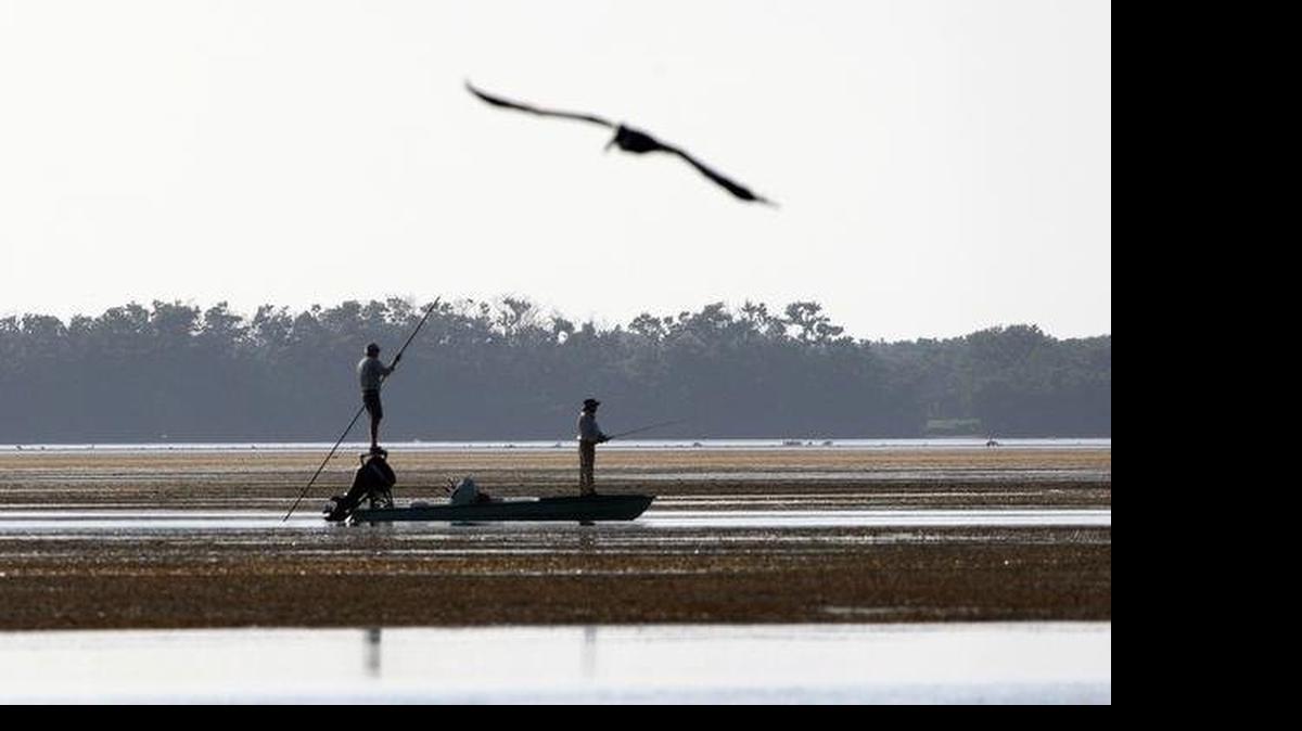 
EVERGLADES SCENE: A fisherman poles his boat in the shallows of Snake Bight in Florida Bay in Everglades National Park.
