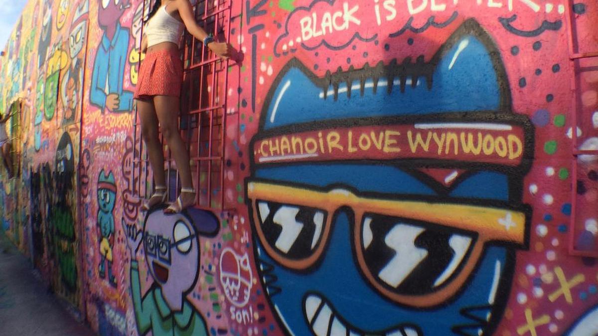 Mural with live model adorns a wall in Wynwood, a neighborhood and arts district undergoing rapid change.