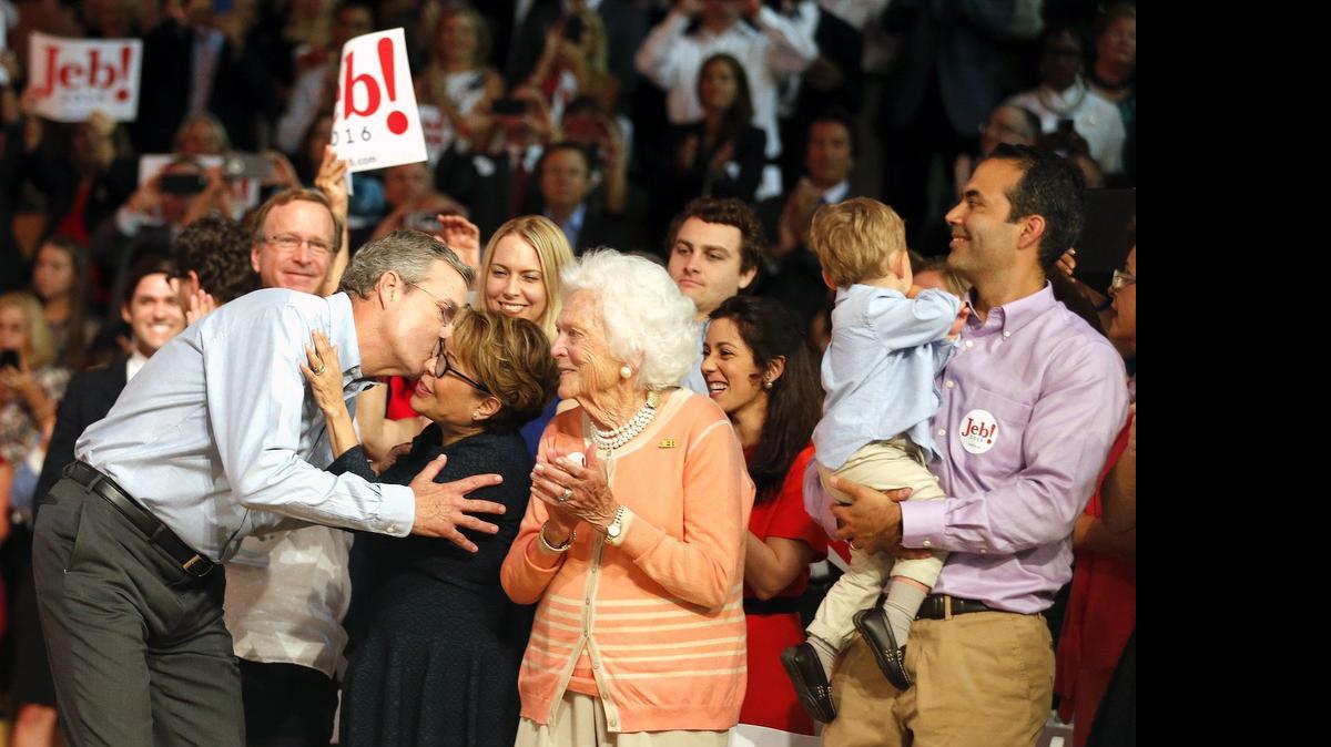 
IN THE RING: Jeb Bush kisses his wife, Columba, as his mother applauds him at the rally on Monday where he officially unveiled his candidacy for president.

