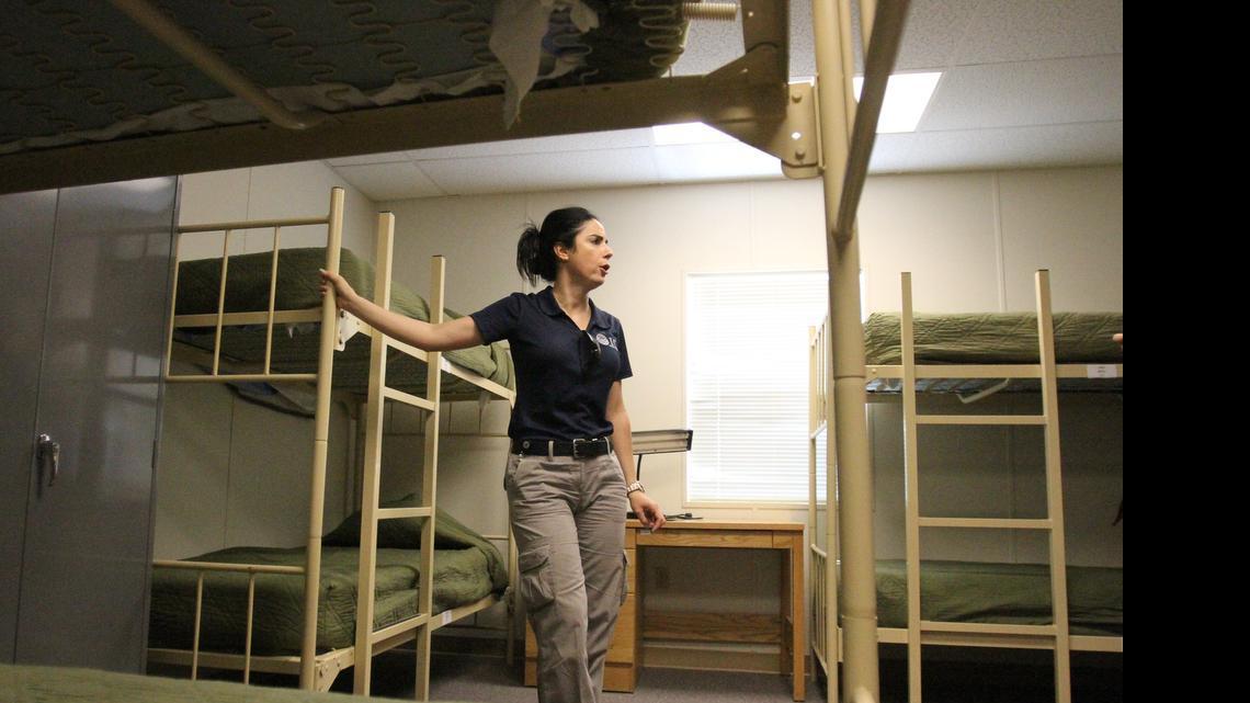 
IMMIGRATION DETENTION: An immigration officer shows a dormitory for immigrant families at a detention center in New Mexico.
