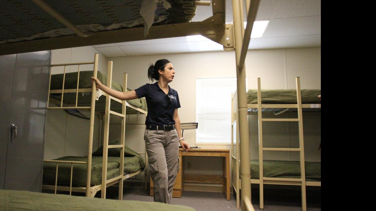 
IMMIGRATION DETENTION: An immigration officer shows a dormitory for immigrant families at a detention center in New Mexico.
