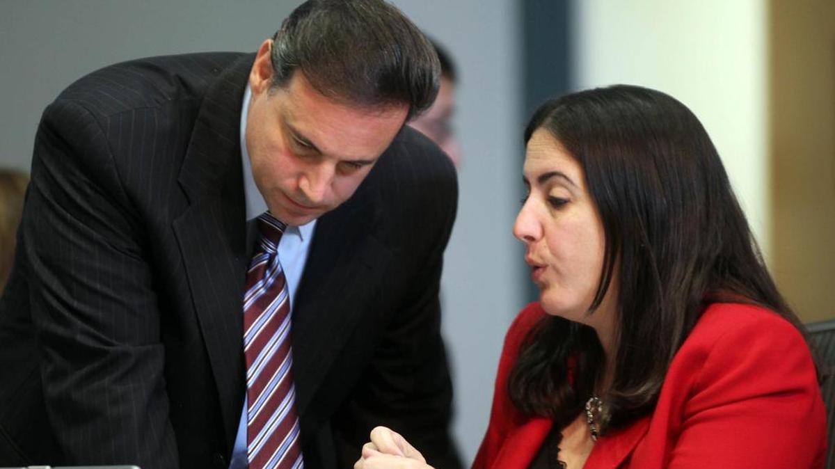 Miami City Attorney Victoria Méndez confers with Commissioner Frank Carollo during a 2014 commission meeting.