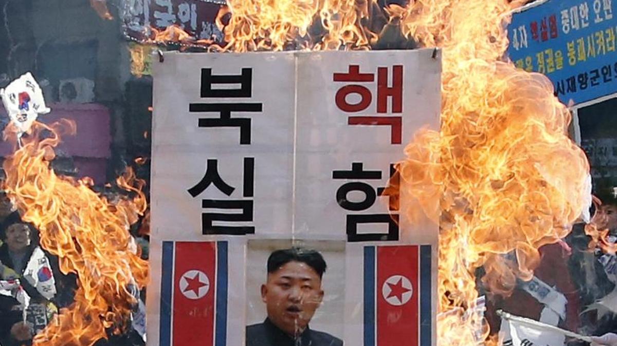 A banner with an image of North Korean leader Kim Jong Un was burned by protestors. It reads, ‘Smash North Korean Nuclear Test.’