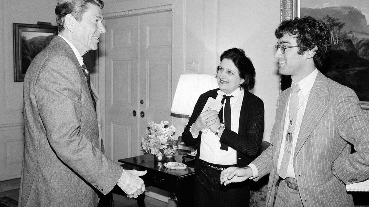 President Ronald Reagan greets UPI reporter Helen Thomas and AP reporter Jim Gerstenzang at the White House in 1981.