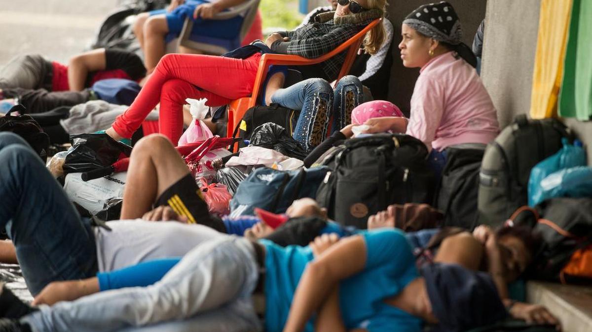 Cuban migrants seeking to reach the U.S. border rest outside the Costa Rican immigration building after they were refused transit across Nicaragua.