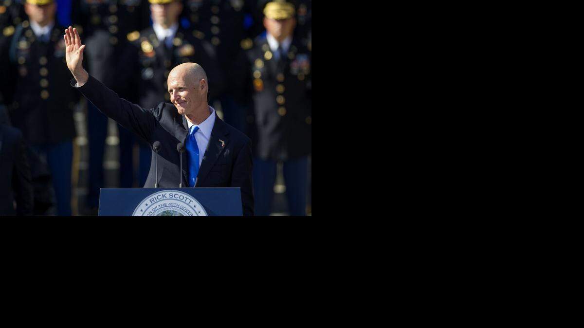 
Rick Scott waves after taking the oath of office for his second term as governor of Florida.
