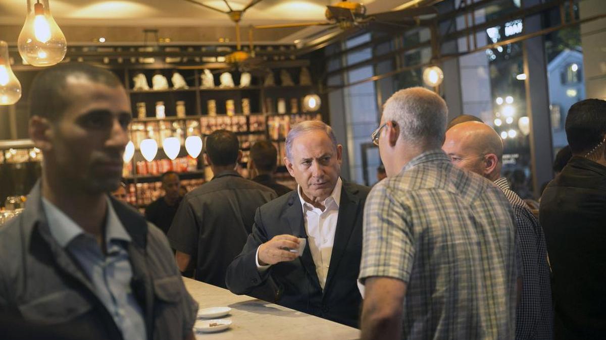 Prime Minister Netanyahu visits the scene of a shooting attack by Palestinian gunmen on Wednesday in Tel Aviv.