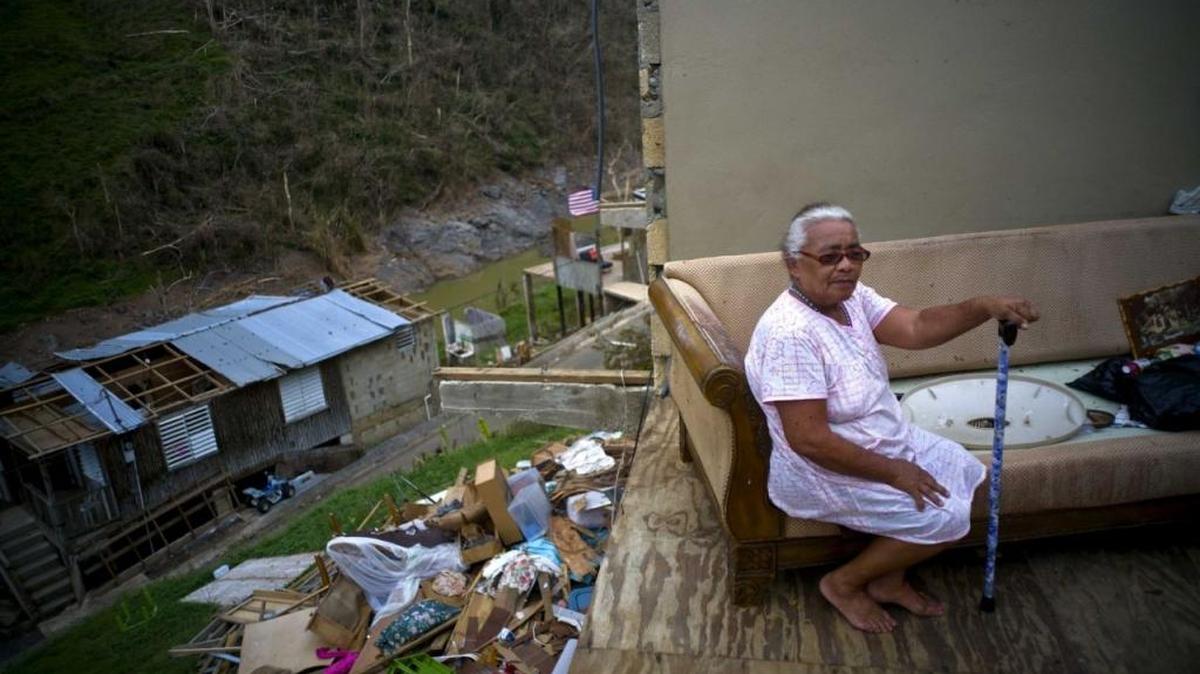 More than 80 days after Hurricane Maria, Juana Sortre Vazquez lives in half of what used to be her home, by a highway .