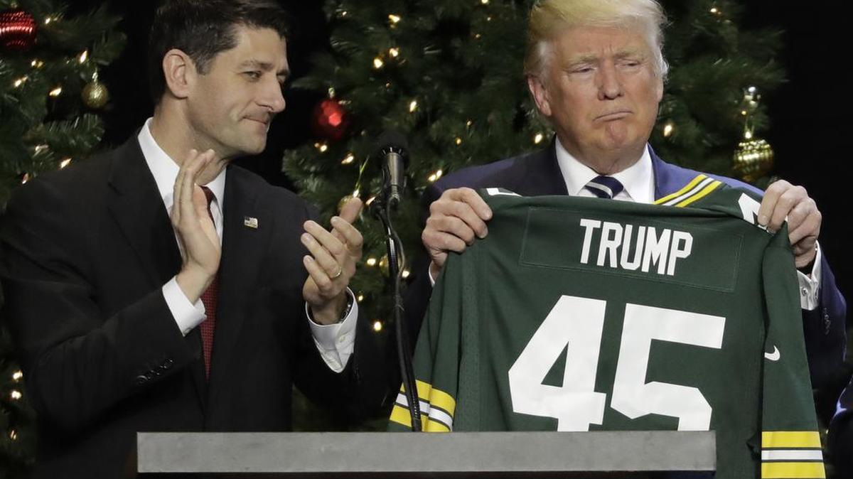 President-elect Donald Trump holds up Green Bay Packers jersey given to him by House Speaker Paul Ryan at a rally in Wisconsin on Tuesday.