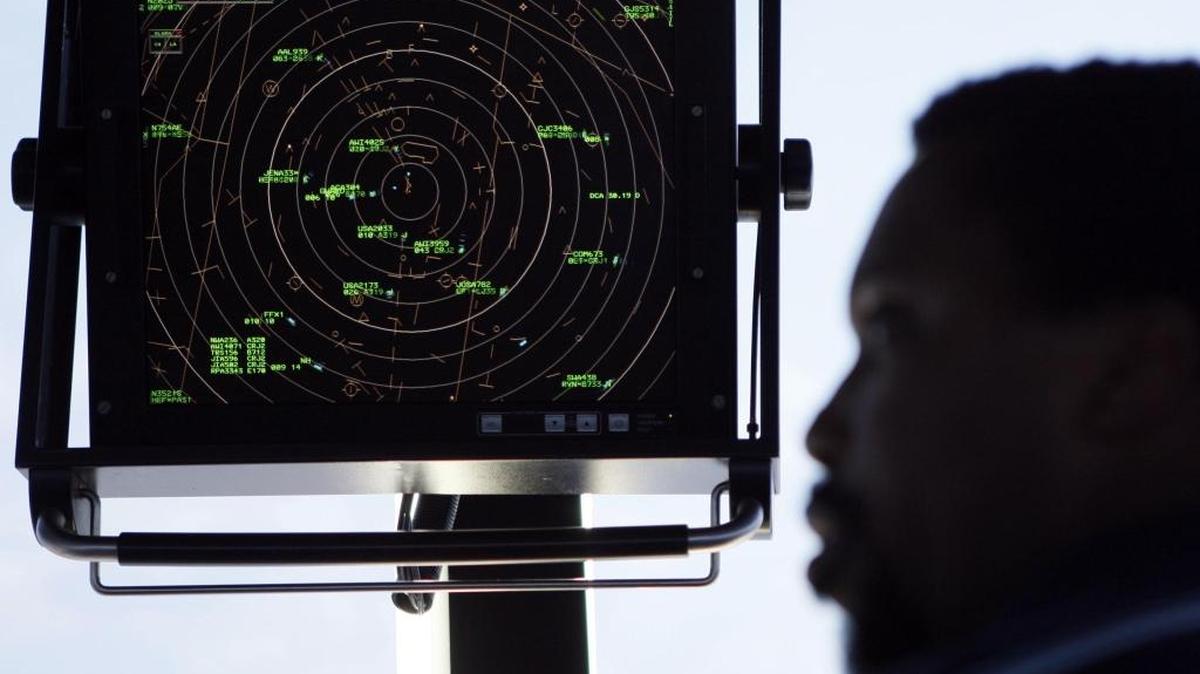 An air traffic controller with a radar screen in the control tower at Washington’s Reagan National Airport.