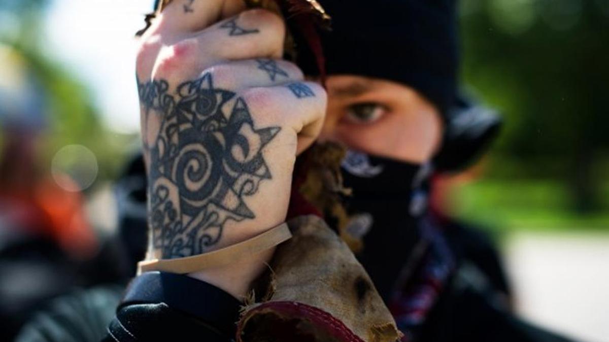 In June, a man in Colorado belonging to the Antifa — “anti-facist” — movement holds up the remains of a burned American flag.