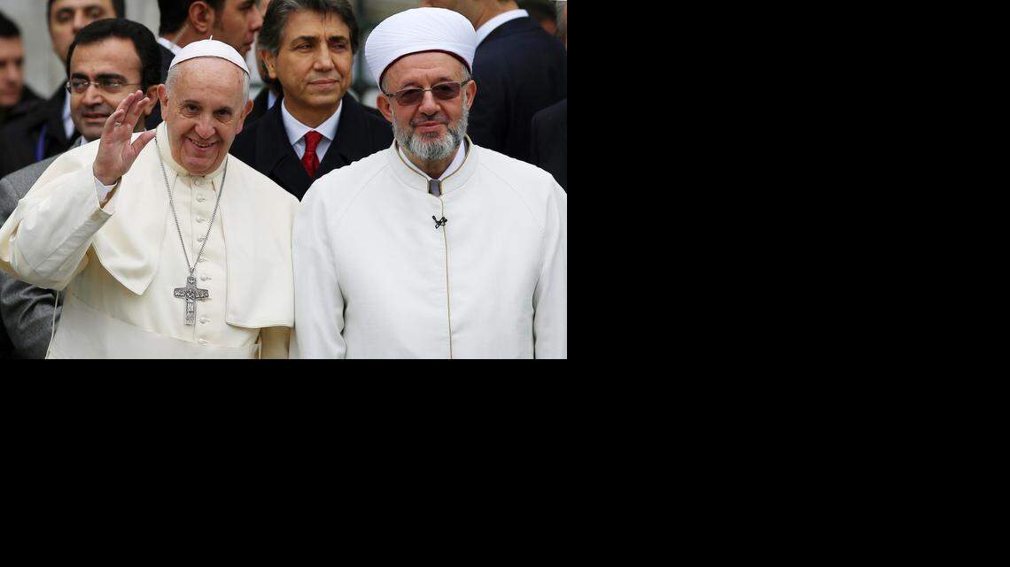 
POPE IN TURKEY: Pope Francis waves to journalists as he stands by Istanbul Mufti Rahmi Yaran during his trip to the Muslim nation last November.
