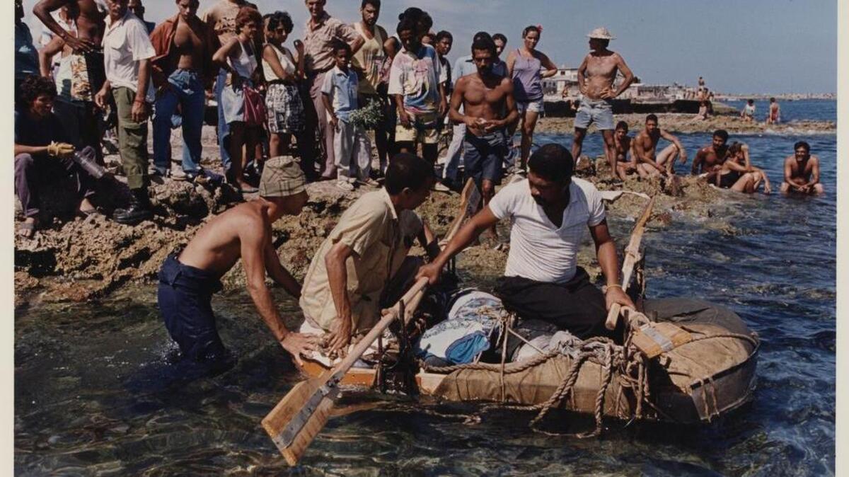 Cuban rafters prepare to leave from the shores of Cojimar while others look on.