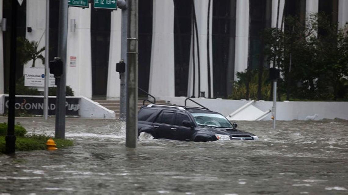 An SUV drives on flooded Brickell Avenue in Miami as Hurricane Irma blows through in September.
