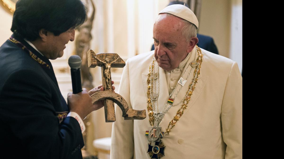 
SYMBOLIC ‘GIFT’: Bolivian President Evo Morales presents Pope Francis with a crucifix carved into a wooden hammer and sickle.
