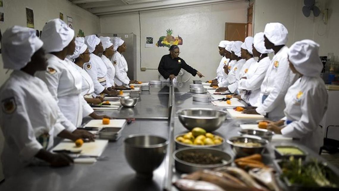 Chef Marie Solange Chevalier instructs students at the Hoteliere D’Haiti school in Port-au-Prince, Haiti, where young people are preparing for careers as chefs and food-industry professionals.